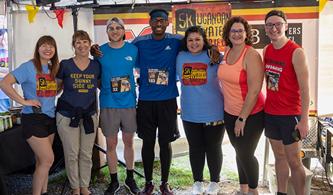 Roberts community pose for photo at race